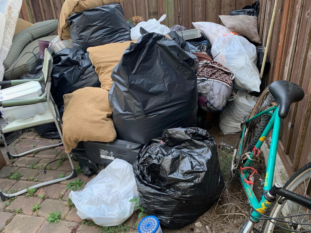 Picture of a bunch of junk in a backyard ready to be removed