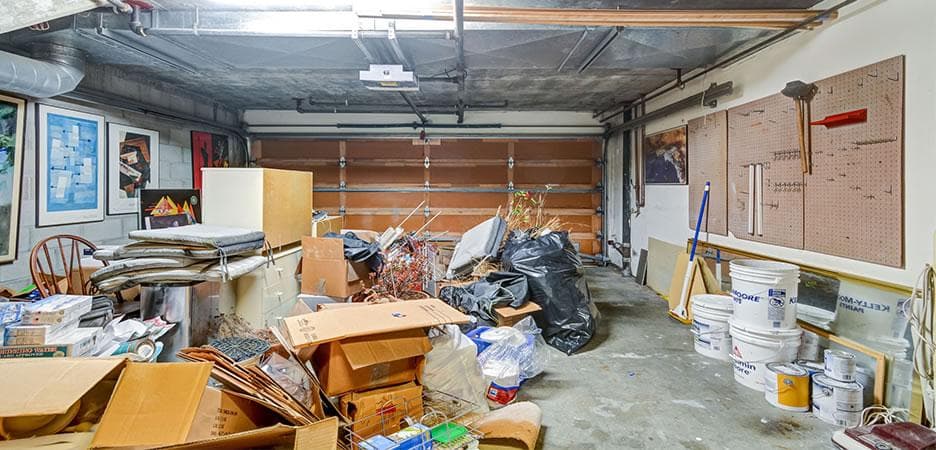 picture of a garage full of junk that needs to be removed